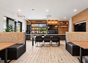 Thumbnail 9 of 29 - A modern dining area with wooden floors and furniture.