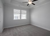 Thumbnail 13 of 27 - a bedroom with a ceiling fan and two windows