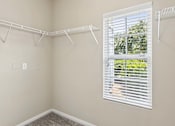 Thumbnail 16 of 38 - A room with a white wall and a window with blinds.