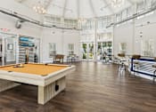 Thumbnail 20 of 38 - A pool table is in the middle of a room with a bar and a pool table.