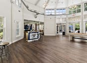 Thumbnail 17 of 38 - A large open space with wood flooring and a bar area.