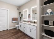 Thumbnail 85 of 94 - a bathroom with white cabinets and a toilet and a sink