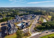 Thumbnail 48 of 49 - an aerial view of a large complex of buildings with a pool in the middle of the road