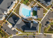 Thumbnail 49 of 49 - an aerial view of a resort property with a swimming pool and parking lot