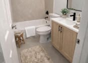 Thumbnail 7 of 15 - A bathroom with a white tub, toilet, and sink.