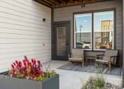 Thumbnail 91 of 94 - the front porch of a home with two chairs and a table