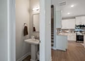 Thumbnail 13 of 65 - A bathroom with a sink and mirror is shown.