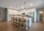 Thumbnail 4 of 65 - A kitchen with a table and chairs in the middle of the room.
