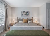 Thumbnail 18 of 65 - A bedroom with a large bed and a green blanket.