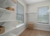 Thumbnail 24 of 65 - A white closet with a basket on the floor.