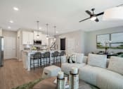 Thumbnail 30 of 65 - A modern living room with a dining area and kitchen in the background.