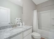 Thumbnail 48 of 65 - A bathroom with a sink, toilet, and bathtub.