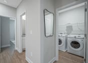 Thumbnail 49 of 65 - A laundry room with a washer and dryer.