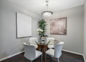 Thumbnail 5 of 38 - A dining room with a glass table and white chairs.