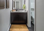 Thumbnail 10 of 38 - A bathroom with a sink and mirror.