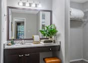 Thumbnail 13 of 38 - A bathroom with a vanity and a mirror.