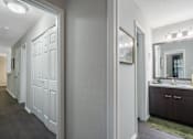Thumbnail 9 of 38 - A bathroom with a vanity and a mirror.