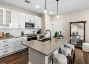 Thumbnail 67 of 94 - a kitchen with a large island and white cabinets