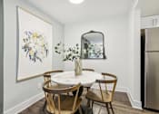 Thumbnail 6 of 28 - A dining room with a white table and chairs.