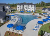 Thumbnail 18 of 54 - an aerial view of a swimming pool with lounge chairs and umbrellas in front