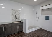 Thumbnail 23 of 31 - A bathroom with a shower and a sink.