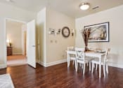 Thumbnail 6 of 42 - A dining room with a white table and chairs.