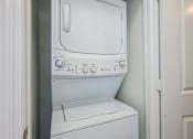 Thumbnail 24 of 35 - A white washing machine with a blue and white control panel.