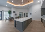 Thumbnail 5 of 28 - a large kitchen with a center island and a dining room with tables and chairs