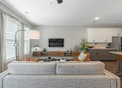 Thumbnail 28 of 71 - a living room with a couch and a table