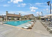Thumbnail 50 of 71 - the resort style pool is surrounded by lounge chairs