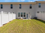 Thumbnail 38 of 71 - a white house with a yard and a fence