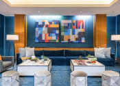 Thumbnail 23 of 47 - a living room with blue walls and furniture and a colorful wall art