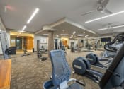 Thumbnail 33 of 47 - a gym with cardio machines and weights at the enclave at woodbridge apartments