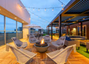 Thumbnail 39 of 47 - a patio with chairs and a fire pit