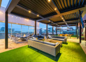 Thumbnail 38 of 47 - a roof top terrace with couches and chairs and a view of the city