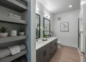 Thumbnail 13 of 21 - a bathroom with a sink and a toilet and a mirror