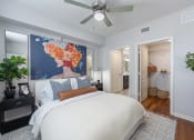 Thumbnail 9 of 38 - a bedroom with a large bed and a ceiling fan
