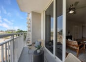 Thumbnail 12 of 38 - the view from the balcony of a condo with a patio and chairs