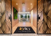 Thumbnail 2 of 38 - a hotel lobby with wooden doors and a sign that reads 160 victory park
