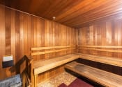 Thumbnail 26 of 38 - a wooden sauna with wooden benches and a chair