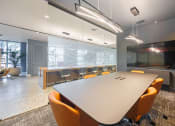 Thumbnail 18 of 38 - a conference room with a table and chairs and a television