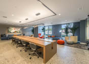 Thumbnail 16 of 38 - a conference room with a long wooden table and chairs