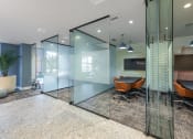 Thumbnail 17 of 38 - a conference room with glass walls and a table and chairs