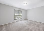 Thumbnail 19 of 35 - an empty room with carpet and a window