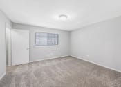 Thumbnail 23 of 35 - an empty room with carpet and a window