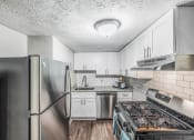 Thumbnail 7 of 35 - a kitchen with stainless steel appliances and white cabinets