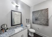 Thumbnail 31 of 45 - a bathroom with a sink toilet and a mirror
