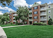 Thumbnail 35 of 37 - A large grassy area in front of apartment buildings.