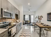 Thumbnail 16 of 30 - A modern kitchen with a black and white checkered floor.