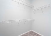 Thumbnail 28 of 49 - A white room with three metal racks on the wall.